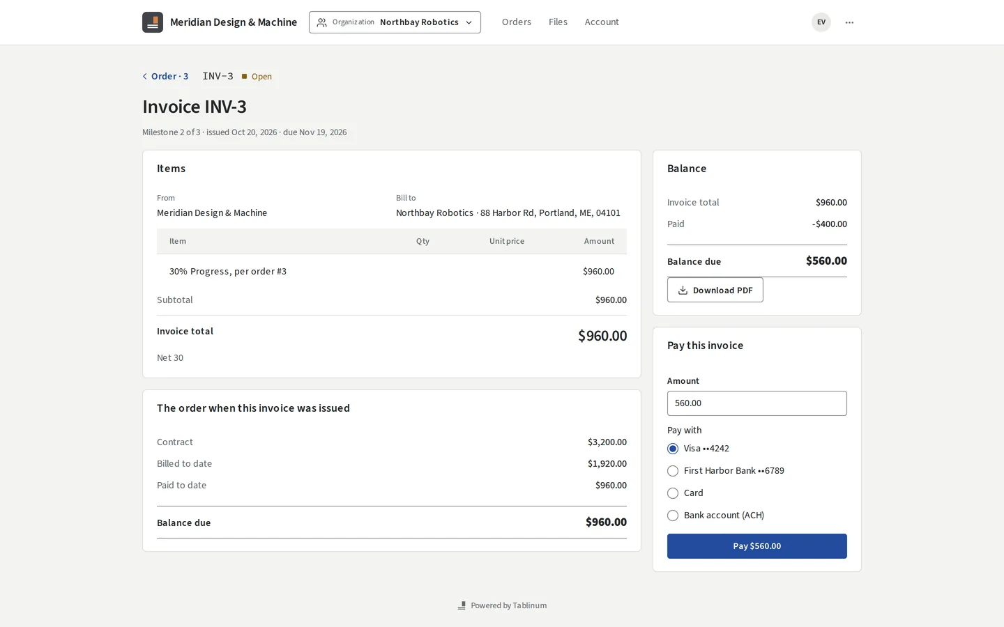 A client paying an invoice online with a saved card or bank account